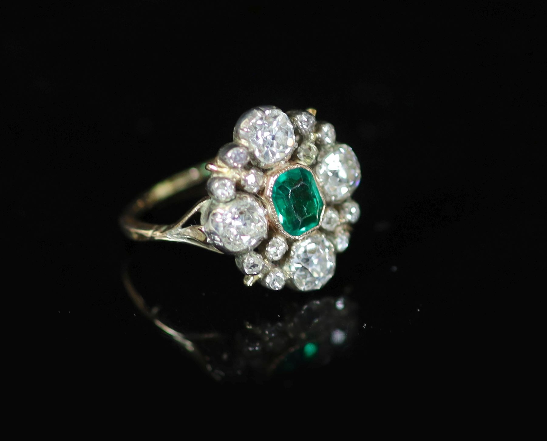 A 19th century gold and silver, emerald and diamond cluster dress ring